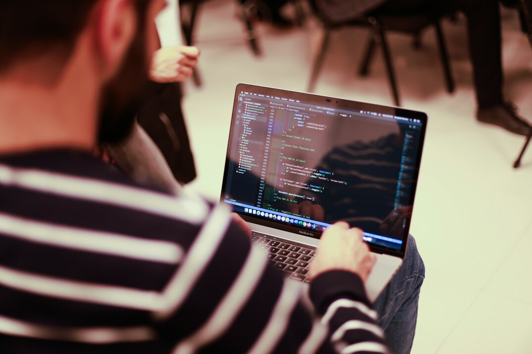 person learning programming on laptop