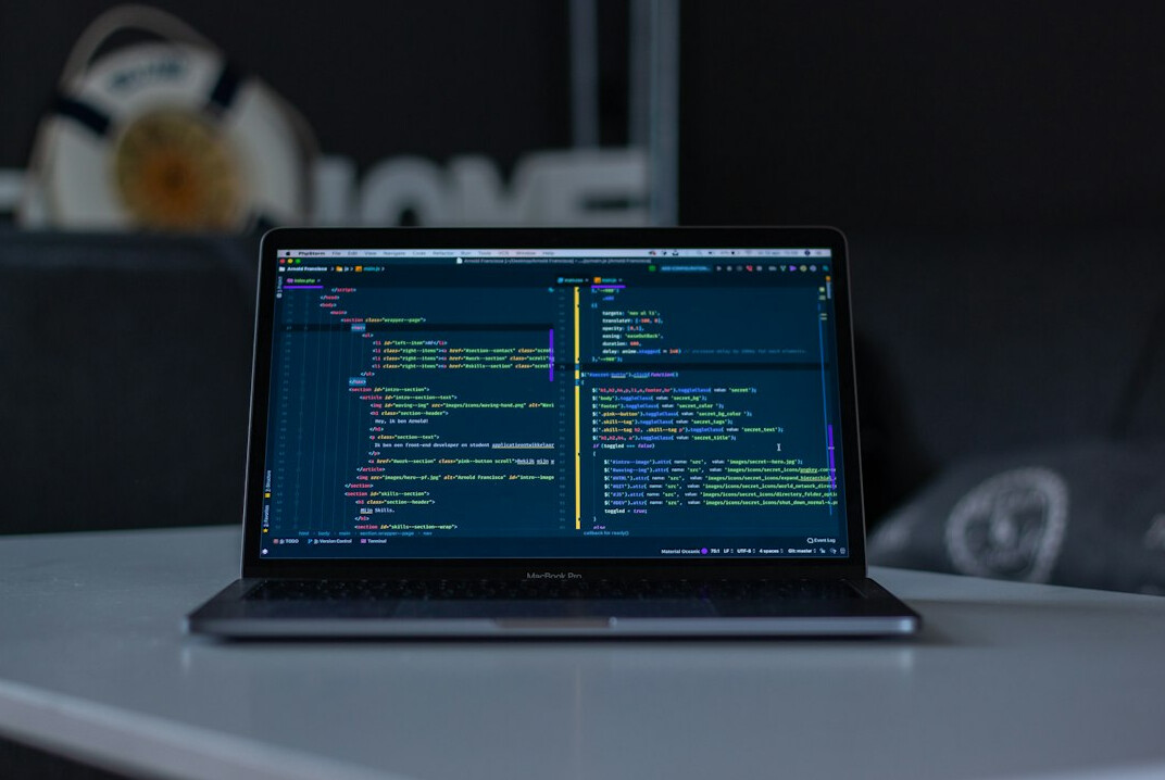person coding on laptop