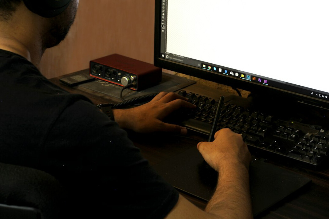 young person coding on laptop